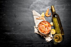 bottle of white wine with shrimp and lemon
