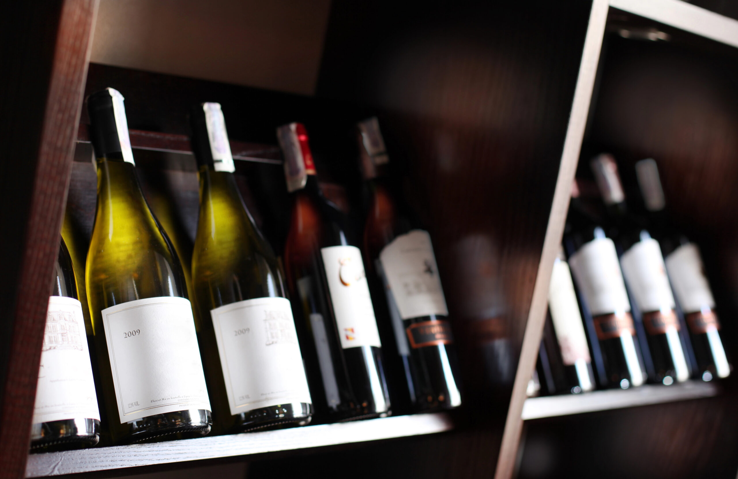 Wine bottles stored on shelves.